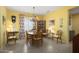 Traditional dining room featuring a chandelier, display cabinet and floral curtains at 19714 N Concord Dr, Surprise, AZ 85374