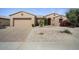 Inviting single-story home showcasing a well-kept desert landscape and brick-paved driveway at 19714 N Concord Dr, Surprise, AZ 85374