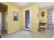 Inviting foyer showcases tile flooring, a glass pane door and bright yellow walls at 19714 N Concord Dr, Surprise, AZ 85374