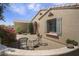 Home's entry courtyard features brick pavers, lush greenery and an inviting seating area at 19714 N Concord Dr, Surprise, AZ 85374