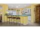 Bright kitchen featuring a breakfast bar with barstool seating, white cabinetry, and a skylight at 19714 N Concord Dr, Surprise, AZ 85374