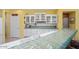 Close-up of the kitchen featuring tile countertops, double sinks, and white cabinetry at 19714 N Concord Dr, Surprise, AZ 85374
