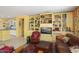 Inviting living room with floor-to-ceiling built-ins and seamless access to the kitchen at 19714 N Concord Dr, Surprise, AZ 85374