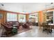 Bright living room featuring a piano, multiple sitting areas, and access to the patio at 19714 N Concord Dr, Surprise, AZ 85374