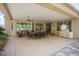 Covered patio featuring dining set and grill, perfect for outdoor entertaining at 19714 N Concord Dr, Surprise, AZ 85374