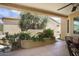 Covered patio with lush landscaping, including a fountain and comfortable seating at 19714 N Concord Dr, Surprise, AZ 85374
