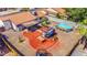 Aerial view of a spacious backyard with a pool, seating area, and trampoline at 2009 W Calle Del Norte Dr, Chandler, AZ 85224