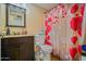 Bathroom with decorated shower curtain, dark vanity, and standard toilet at 2009 W Calle Del Norte Dr, Chandler, AZ 85224