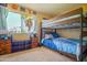 Cozy bedroom with a bunk bed, dresser, and a window view at 2009 W Calle Del Norte Dr, Chandler, AZ 85224