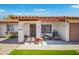 Inviting front porch with seating, fresh flowers, and easy-care artificial turf at 2009 W Calle Del Norte Dr, Chandler, AZ 85224