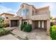 View of the backyard of this house showing off the rockwork and the beautiful two-story home at 22063 N 77Th St, Scottsdale, AZ 85255