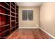 Bedroom with built-in bookcase, neutral paint, and hardwood floors at 22063 N 77Th St, Scottsdale, AZ 85255