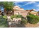 Inviting home with lush landscaping, complemented by a terracotta roof and a two-car garage at 22063 N 77Th St, Scottsdale, AZ 85255