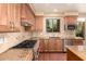 Gourmet kitchen with professional-grade range, custom cabinets, and granite countertops at 22063 N 77Th St, Scottsdale, AZ 85255