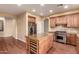 Spacious kitchen with a wine cooler, stainless appliances, custom cabinets, and island with granite countertops at 22063 N 77Th St, Scottsdale, AZ 85255