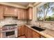 Well-appointed kitchen featuring granite counters, Wolf oven, and custom wood cabinetry at 22063 N 77Th St, Scottsdale, AZ 85255
