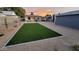 Well-maintained backyard featuring lush artificial turf, gravel landscaping, and a cozy covered patio at 2246 E Yale St, Phoenix, AZ 85006