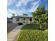 Charming exterior features a white brick facade, well-manicured lawn, and inviting turquoise front door at 2246 E Yale St, Phoenix, AZ 85006