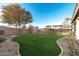 Lush green backyard with mature trees, providing a serene outdoor space at 22500 N Greenland Park Dr, Maricopa, AZ 85139