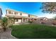 Expansive backyard features lush green lawn and covered patio, perfect for outdoor entertaining at 22500 N Greenland Park Dr, Maricopa, AZ 85139
