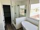 Bathroom featuring glass shower, soaking tub, and a window with a view at 22500 N Greenland Park Dr, Maricopa, AZ 85139