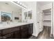 Bathroom boasts double sinks, a large mirror, a shower, and walk-in closet at 22500 N Greenland Park Dr, Maricopa, AZ 85139