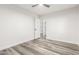 Bright bedroom featuring light walls and gray wood-look floors at 22500 N Greenland Park Dr, Maricopa, AZ 85139