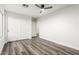 Bedroom with ceiling fan, wood-look floors, and a closet at 22500 N Greenland Park Dr, Maricopa, AZ 85139