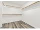 Walk-in closet with wood floors and white walls, with ample hanging space at 22500 N Greenland Park Dr, Maricopa, AZ 85139