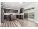 This kitchen features dark wood cabinets, stainless steel appliances, and sliding glass doors to the backyard at 22500 N Greenland Park Dr, Maricopa, AZ 85139