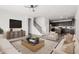 Bright living room with modern furnishings, light wood floors, and neutral colored decor at 22500 N Greenland Park Dr, Maricopa, AZ 85139