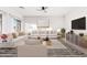 Bright living room with modern furnishings, light wood floors, and neutral colored decor at 22500 N Greenland Park Dr, Maricopa, AZ 85139