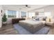 Bright main bedroom features modern decor, hardwood floors, large windows, and ensuite bathroom at 22500 N Greenland Park Dr, Maricopa, AZ 85139