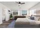 Bright main bedroom features modern decor, hardwood floors, large windows, and ensuite bathroom at 22500 N Greenland Park Dr, Maricopa, AZ 85139