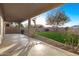 Covered patio overlooking a manicured backyard perfect for outdoor relaxation at 22500 N Greenland Park Dr, Maricopa, AZ 85139
