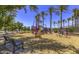 Well-equipped community playground featuring slides and play structures with seating at 22500 N Greenland Park Dr, Maricopa, AZ 85139
