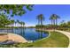 Scenic view of the park pond with palm trees and lush landscaping at 22500 N Greenland Park Dr, Maricopa, AZ 85139