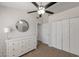 Relaxing bedroom featuring a white dresser, closet, and modern ceiling fan for enhanced comfort at 2301 E University Dr # 256, Mesa, AZ 85213