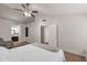 Well-lit bedroom showcasing a vaulted ceiling, a ceiling fan, and an attached bathroom at 2301 E University Dr # 256, Mesa, AZ 85213