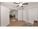 Bright room with hardwood floors and open doorway to cozy living area featuring convenient closet at 2301 E University Dr # 256, Mesa, AZ 85213
