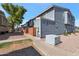 Charming townhome featuring neat landscaping and brick accents near sidewalks under a clear blue sky at 2301 E University Dr # 256, Mesa, AZ 85213
