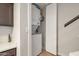 Convenient laundry area featuring a stacked washer and dryer, optimizing space and functionality at 2301 E University Dr # 256, Mesa, AZ 85213