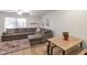 Cozy living room with plush sectional sofa, stylish rug, and natural light enhancing a comfortable ambiance at 2301 E University Dr # 256, Mesa, AZ 85213