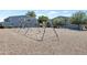 Community playground featuring swings and play structures between two residential buildings at 2301 E University Dr # 256, Mesa, AZ 85213