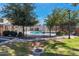 Community pool enclosed by a black fence, surrounded by greenery and trees at 2301 E University Dr # 256, Mesa, AZ 85213