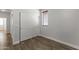 A small bedroom with hardwood floors and a closet, complemented by natural light at 2363 W Dusty Wren Dr, Phoenix, AZ 85085