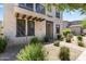 Charming home with a stucco exterior, dark trim, a covered entry, and desert landscaping at 2363 W Dusty Wren Dr, Phoenix, AZ 85085