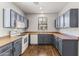 Efficient kitchen featuring gray cabinets, laminate countertops, and white appliances, all on wood-look vinyl flooring at 2363 W Dusty Wren Dr, Phoenix, AZ 85085