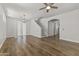 Open-concept living room features hardwood floors, a ceiling fan and leads to the stairs at 2363 W Dusty Wren Dr, Phoenix, AZ 85085