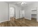 Spacious main bedroom featuring wood-look flooring, neutral paint, and an archway at 2363 W Dusty Wren Dr, Phoenix, AZ 85085